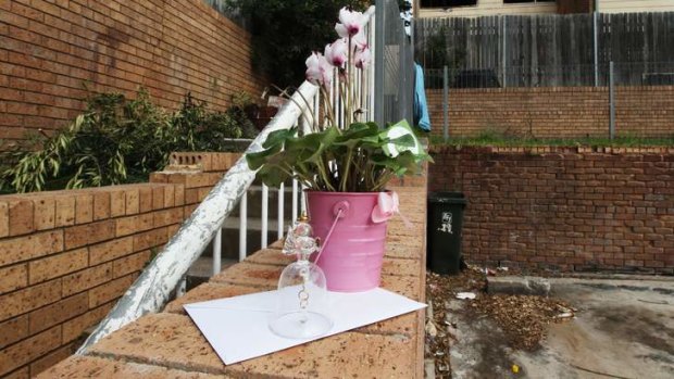 Flowers left in memory for girl who died in the house fire.