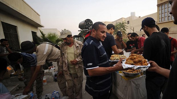 Libyan rebels prepare to break their fast with the "iftar" meal in the capital Tripoli.