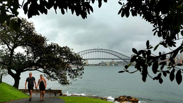 A couple walk through the Royal Botanic Gardens on Sunday.