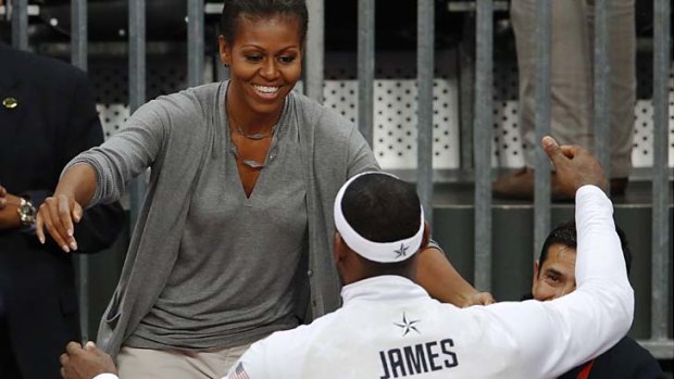 US First Lady Michelle Obama hugs LeBron James.