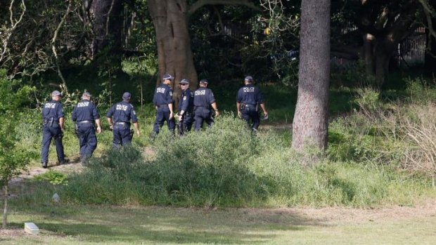Police search the more remote corners of Centennial Park for Michelle Levy on Sunday.