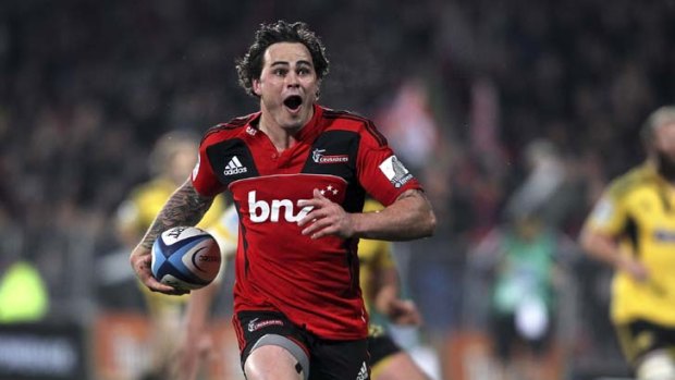 Runaway try ...  Zac Guildford scoots between the Hurricanes defence to score for the Crusaders.