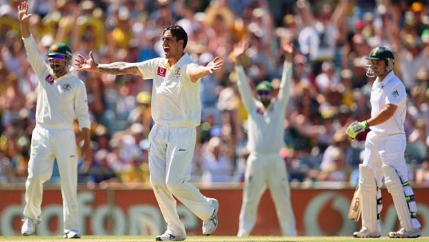 Double breakthrough ... Mitchell Johnson successfully appeals for an lbw decision to dismiss Dean Elgar.