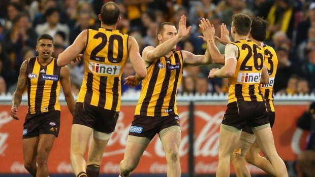Jarryd Roughead is congratulated by teammates after kicking a goal.
