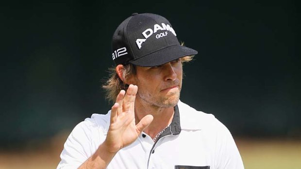 Aaron Baddeley of Australia waves to the gallery on the third green.
