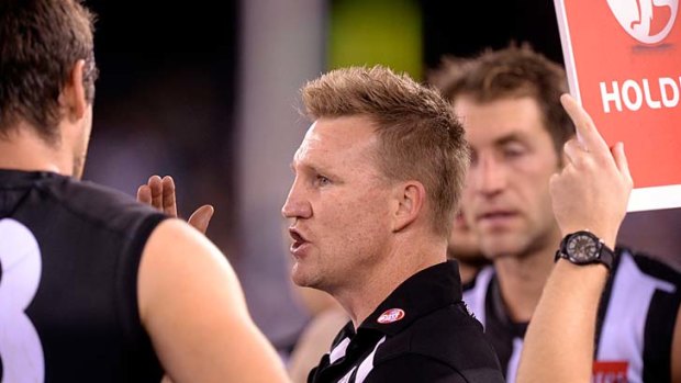 Collingwood coach Nathan Buckley addresses his troops at quarter-time.