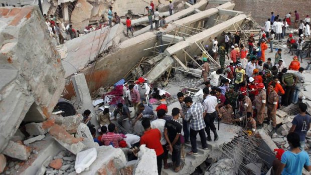 People scramble to free trapped garment workers in the Rana Plaza building which collapsed outside Dhaka.