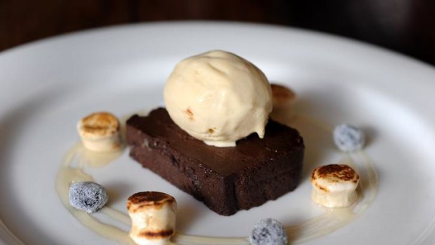Baked chocolate fudge terrine  with frosted blueberries, espresso marshmallows and pinenut flavoured ice cream.