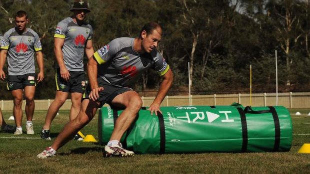 Raiders captain Terry Campese steps around the tackle bags at training.