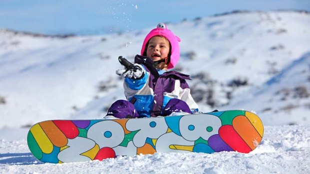 Holly Cook, 7, enjoys her first day on the snowboard at Falls Creek.