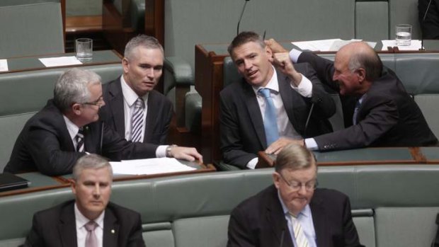 Independent MPs Andrew Wilkie, Craig Thomson, Rob Oakeshott and Tony Windsor talk during the motion of no confidence during question time.