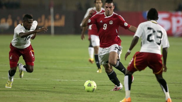 Amr Zaki of Egypt takes on the Ghana defence in Cairo.