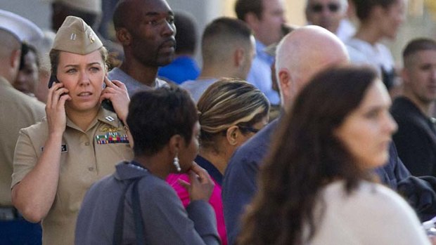 Gun deaths: Worried families and friends wait to greet survivors of this week's Washington Navy Yard shootings.