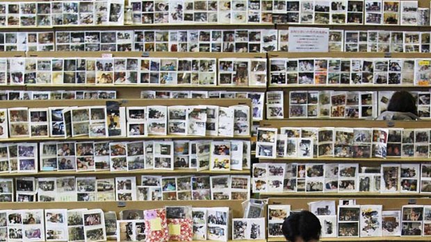 A year later &#8230; looking for personal photographs at a tsunami collection centre for effects in Sendai.
