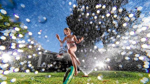Seven-year-old Niamh cools down under the sprinkler in her backyard in Melbourne's inner west yesterday.