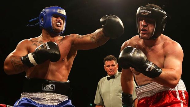 Punching on &#8230; Sharks skipper Paul Gallen works the body of Hika Elliot in his boxing debut.