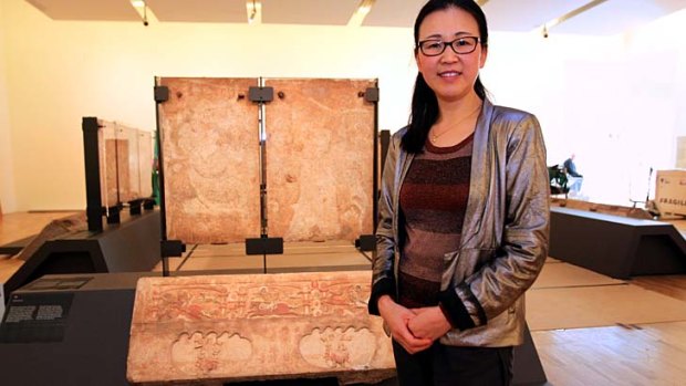Unique carvings: Curator Cao Yin with marble panels being installed for <em>A Silk Road Saga</em>.