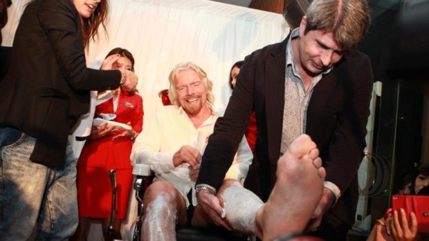 Richard Branson gets his legs shaved in preparation for his first flight as an air stewardess on an Air Asia flight.