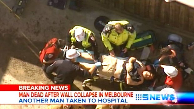 A still from Nine News, showing a man being attended to by paramedics at the scene of the Caulfield Wall collapse.