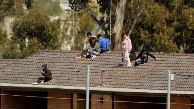 Nine on the roof ... fresh rooftop protest breaks out at Villawood detention centre.