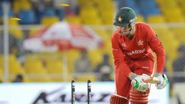 Beaten for pace: Zimbabwe batsman Brendan Taylor loses his middle stump to speedster Shaun Tait, who finished with two wickets.