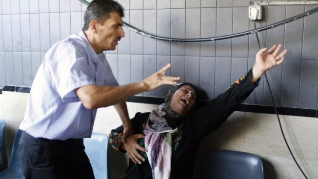The mother of a Palestinian boy reacts following his death at a hospital in Gaza.