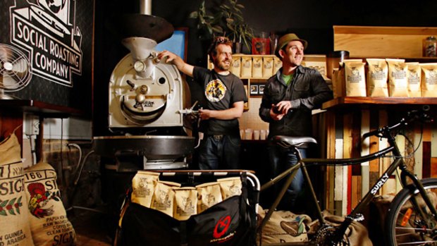 Social Roasting Company's Gabe Davidson (right) with chief roaster Jeremy Jenkins and one of the company's delivery bicycles.