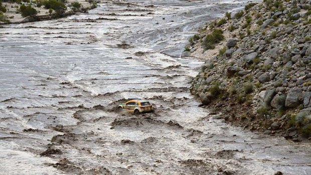 Stuck fast: The car of Brazilian Guilherme Spinelli is caught in floodwaters in Argentina.