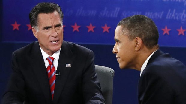 Mitt Romney reacts as US President Barack Obama makes a point during the third presidential debate.