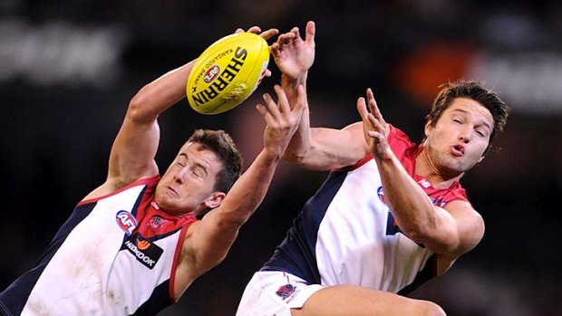 Demons attack: Melbourne's Daniel Nicholson, left, and Stefan Martin contest a mark during Friday's win.