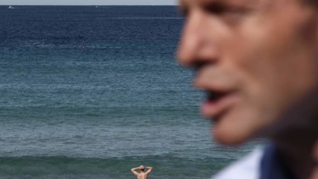 Opposition Leader Tony Abbott defends his spending and savings measures at Bondi Beach, Sydney, on August 11.