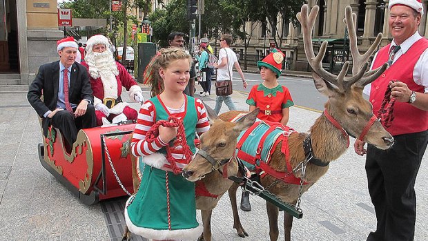 Brisbane Lord Mayor Graham Quirk gets into the Christmas spirit in the Queen Street Mall.