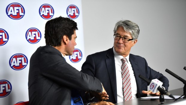 AFL CEO Gillon McLachlan shakes hands with Fitzpatrick after the latter announced his retirement.