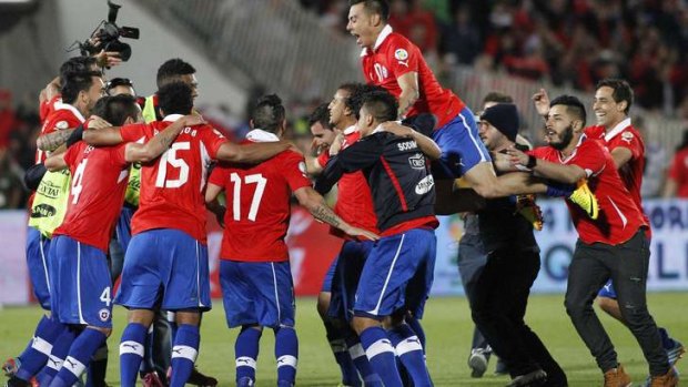 Chilean players celebrate qualifying for the 2014 World Cup after the final whistle in Santiago.