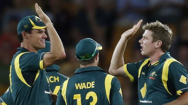 Australia's Clint McKay (left) congratulates teammate James Faulkner (right) after he took the wicket of the West Indies' Chris Gayle in Canberra in February.