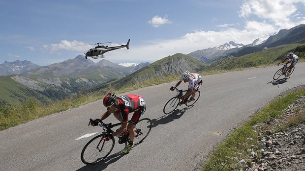 Brutal stage ... Evans and teammate Tejay van Garderen of the US, wearing the best young rider's white jersey, speed down Croix de Fer pass.