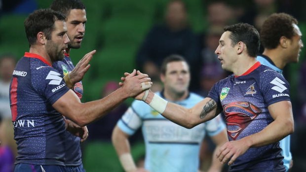 On fire: Billy Slater is congratulated by Storm captain Cameron Smith after scoring a try.