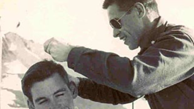 Maurice Cutler, aged 18, is given a hair cut at McMurdo Sound by Commander Gus Shinn, the first pilot to land a plane at the South Pole.