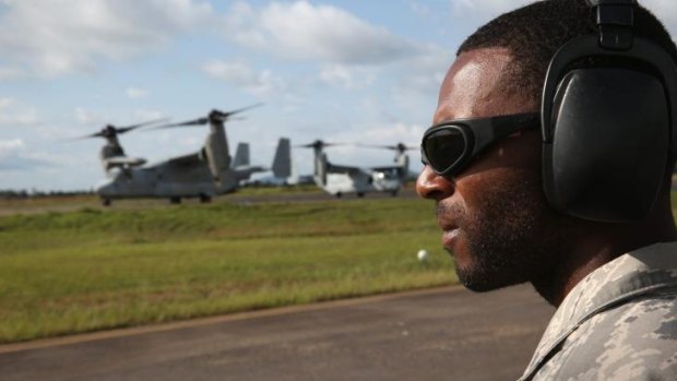 A member of the US Air Force looks on as US Marines arrive in Monrovia, Liberia. US President Barack Obama has committed up to 4000 troops to the region.