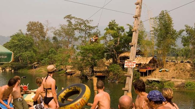 Tourists enjoy one of Vang Vieng's riverside bars. In the wake of several high-profile deaths, a crackdown by authorities has seen many of the bars closed down.