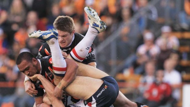 Upended &#8230; Anthony Minichiello gets mauled by Tigers.