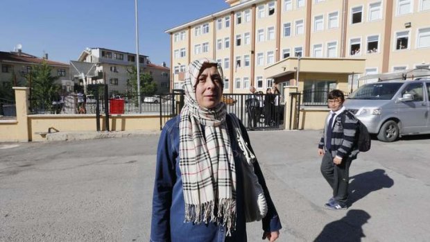 Safiye Ozdemir, 45, stands in front of a school where she works in central Ankara. Turkey has lifted a ban on women wearing the Islamic head scarf in state institutions.
