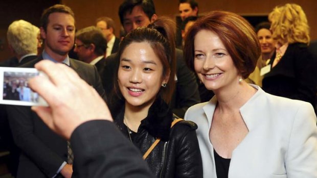 Summit focus &#8230; the Prime Minister, Julia Gillard, poses with a student at Yonsei University, Seoul.