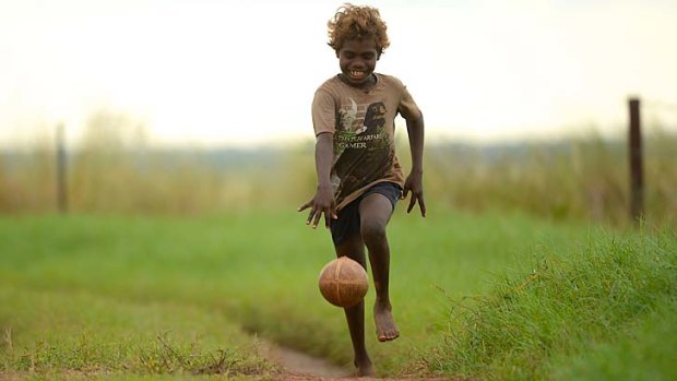 Robert Dirdi enjoys a run and bounce at the Gunbalanya School.
