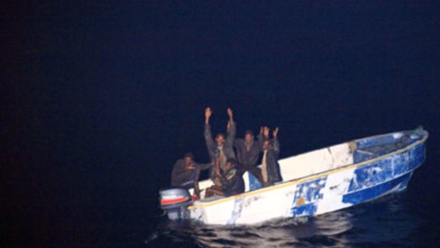 Picking on the wrong crew ... (top) Somali pirates holding their hands up to soldiers, left, of the French vessel La Somme and (bottom) the La Somme.