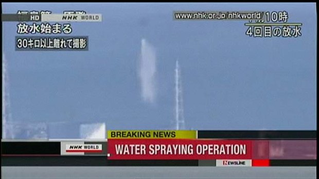 A television image of the helicopter water bombing the plant.