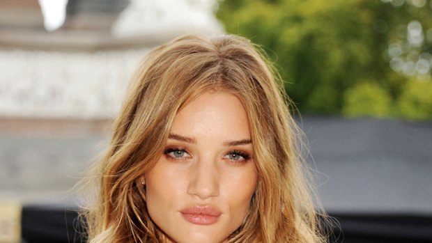 The price of beauty ... are good-looking people like lingerie model and actress Rosie Huntington Whiteley, above, "worth" more?