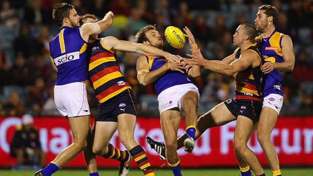 Entertainer: Eagle Mark LeCras juggles a mark under great pressure from two Crows.