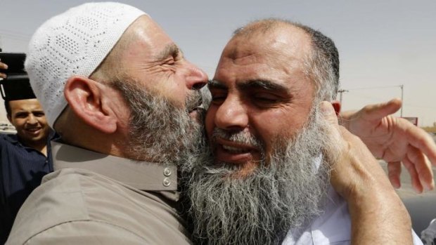 Radical Muslim cleric Abu Qatada (right) hugs his father after being released from a prison near Amman.