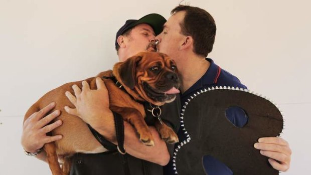 Something to celebrate: Gary Kennedy and partner Andrew Moloney with dog Max.